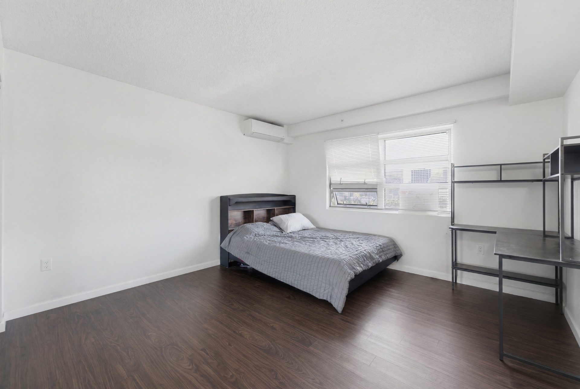 Third bedroom with queen bed, bookcase headboard, and desk area