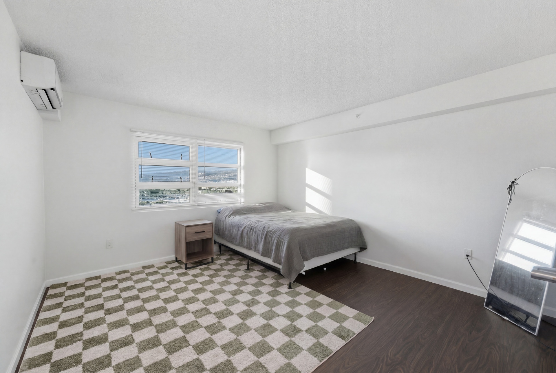 Bedroom with queen bed, nightstand, and window with mountain view