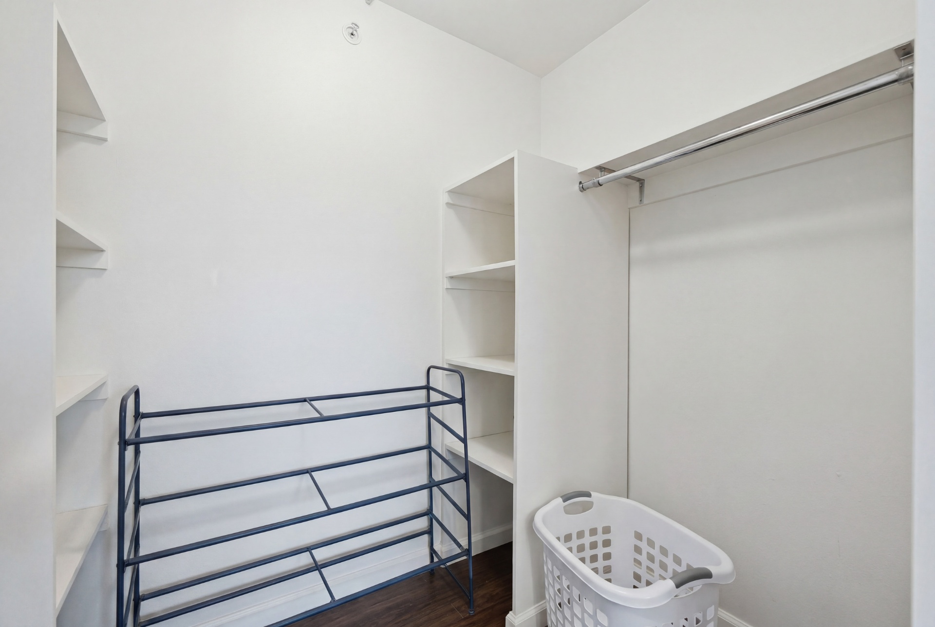 Walk-in closet with built-in shelving and hanging rod