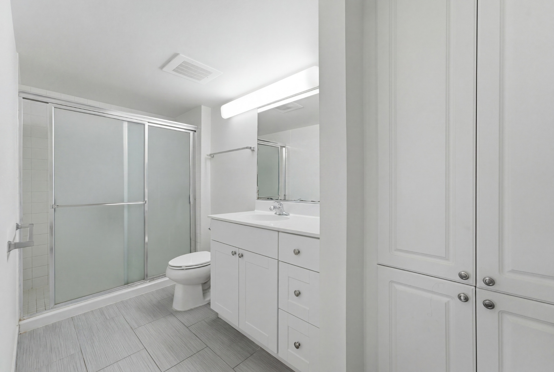 Bathroom with walk-in shower, vanity, and linen closet